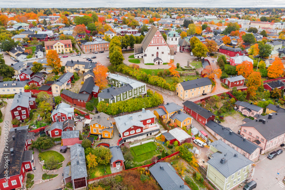 Aerial autumn view of Old town of Porvoo, Finland. Beautiful city landscape with idyllic river Porvoonjoki, old colorful wooden buildings and Porvoo Cathedral.