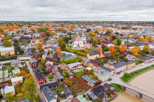 Aerial autumn view of Old town of Porvoo, Finland. Beautiful city landscape with idyllic river Porvoonjoki, old colorful wooden buildings and Porvoo Cathedral.