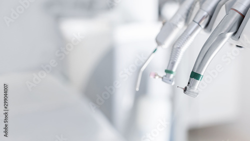 Different dental instruments and tools in dentist office photo