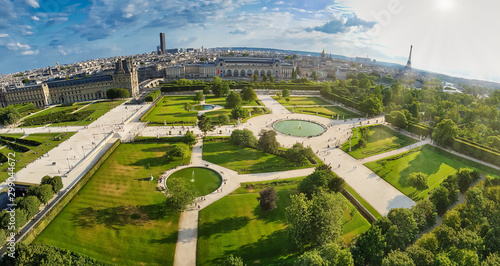 very wide angle panoramic aerial view of the famous Jardin des Tuileries park of Paris near the Louvre showing in the far horizon the tower of Eiffel  photo