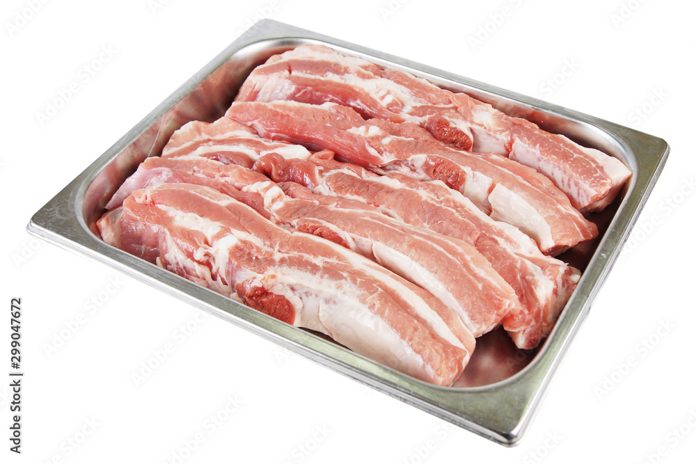 A few pieces of fresh pork in a metal tray A few pieces of fresh pork in a metal tray