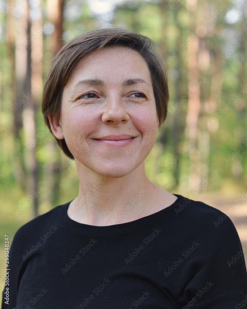 Natural portrait of a smiling short-haired woman in nature Natural portrait of a smiling short-haired woman in nature