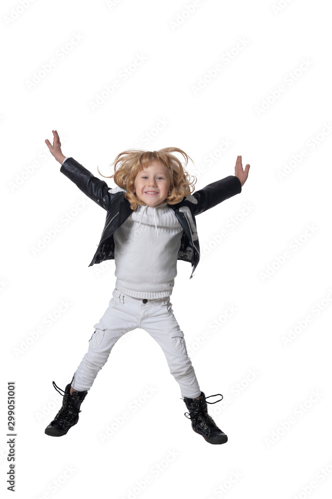 Portrait of handsome little boy jumping against white background