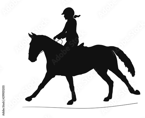 Silhouette of a young rider on a sports pony in the arena