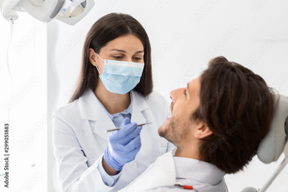 Close up of man having check up in dental office