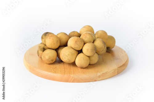 Fresh longkong fruit on wooden plate and white background