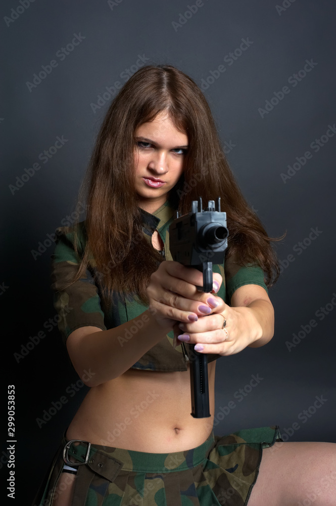 Beautiful girl in army costume aims at gun Beautiful girl in army costume aims at gun