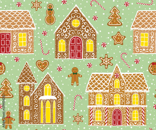 Christmas gingerbread seamless pattern with gingerbread houses on green background
