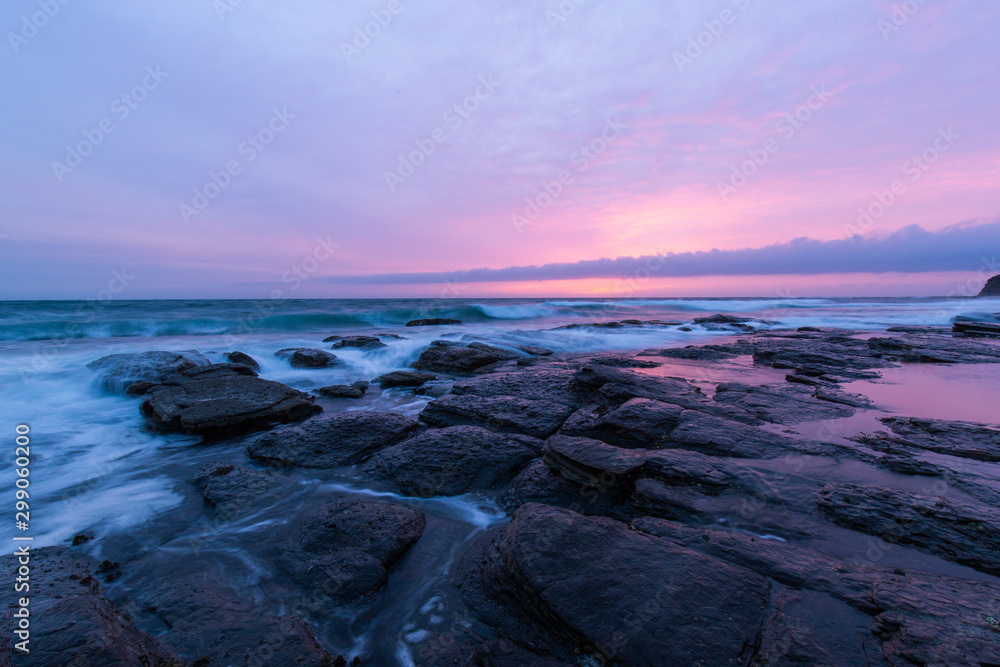 Scenic view of rock formation on the coastline with sunrise sky. Scenic view of rock formation on the coastline with sunrise sky.