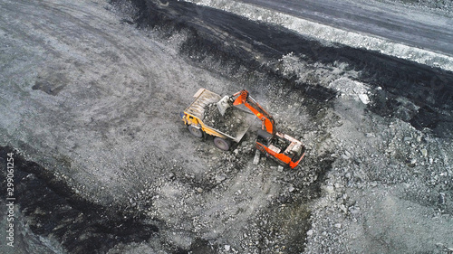 Coal mining in a quarry. A hydraulic excavator loads a dump truck.