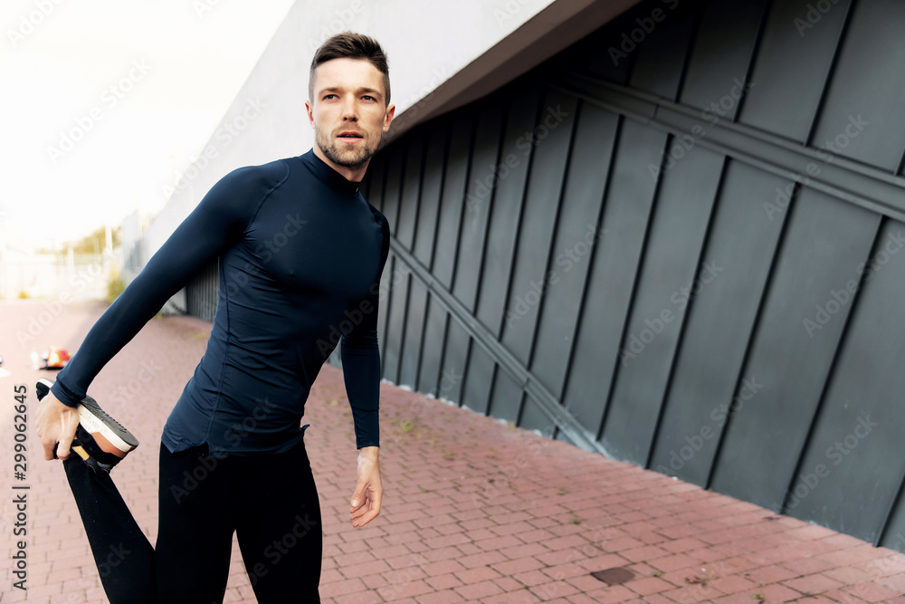 fitness, sport, training and lifestyle concept - smiling man stretching hand outdoors fitness, sport, training and lifestyle concept - smiling man stretching hand outdoors