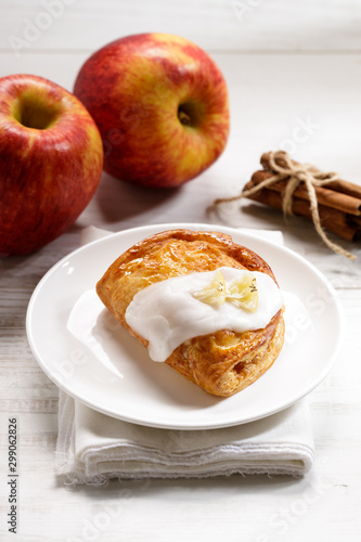 piece of cinnamon apple pie on a white plate with fresh apple in background, autumn food concept