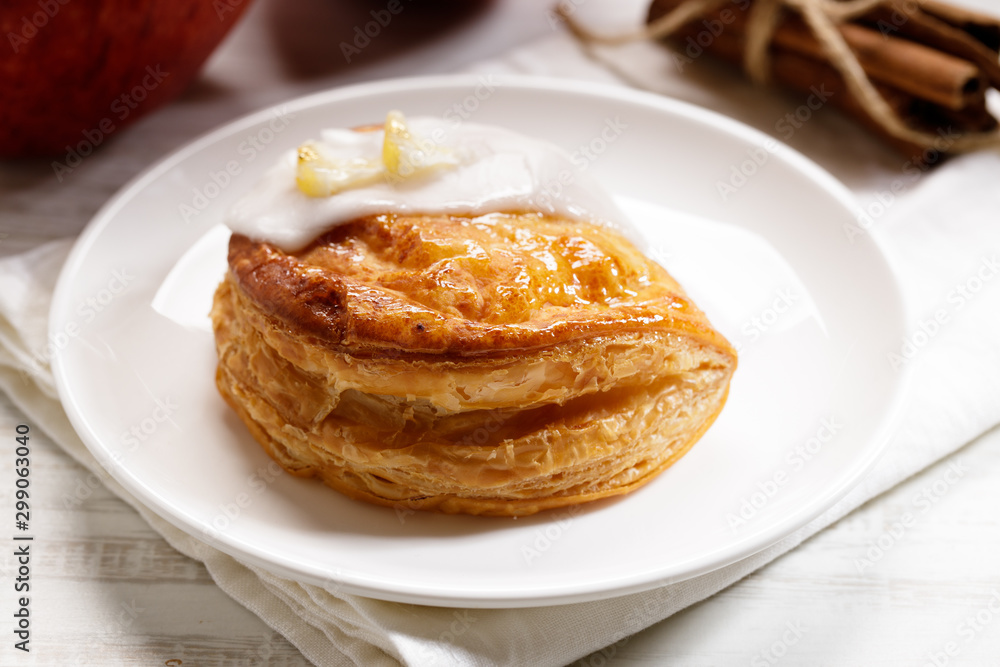 piece of cinnamon apple pie on a white plate with fresh apple in background, autumn food concept piece of cinnamon apple pie on a white plate with fresh apple in background, autumn food concept