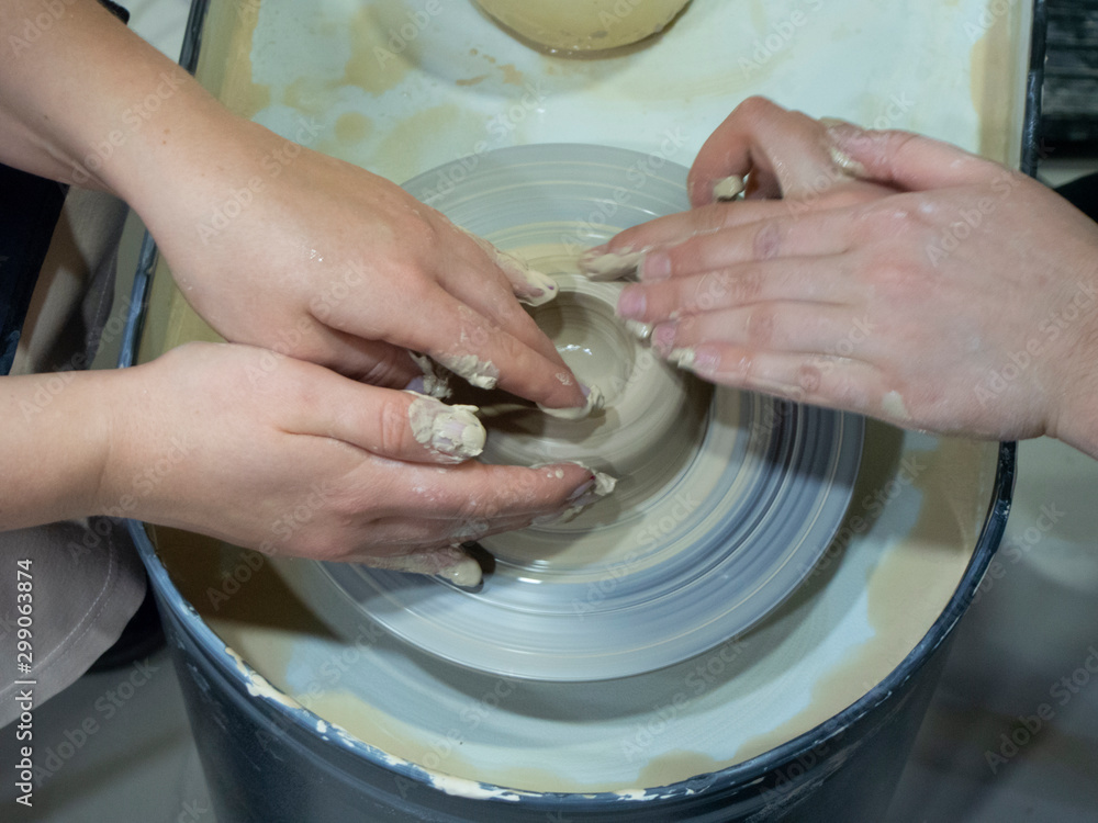 working with clay behind a Potter's wheel working with clay behind a Potter's wheel