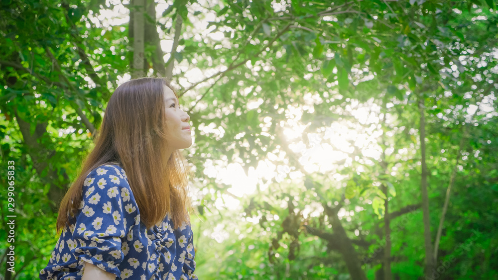closeup outdoor asian girl sitting in the park breathe fresh air and soft sunlight. Hopeful life concept. closeup outdoor asian girl sitting in the park breathe fresh air and soft sunlight. Hopeful life concept.