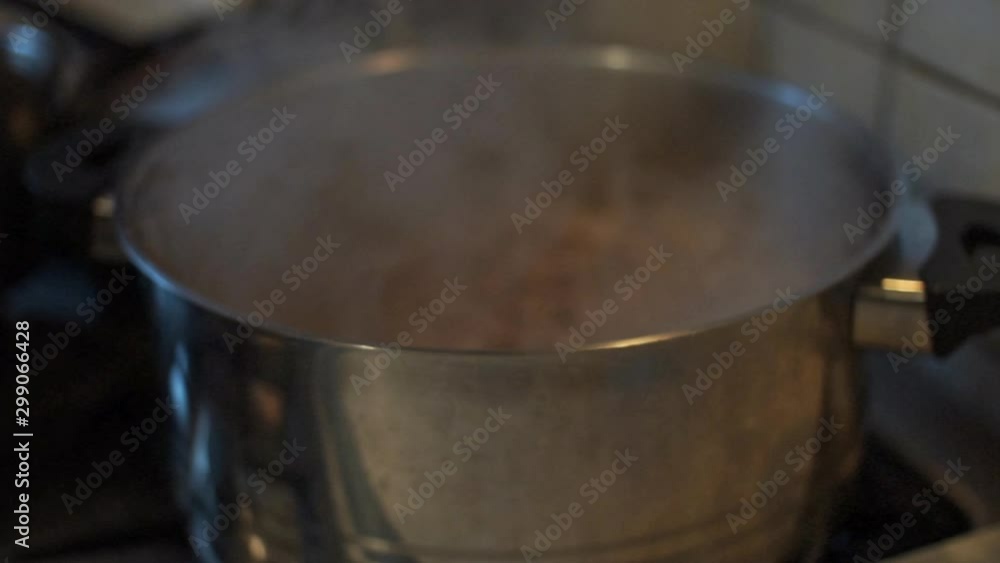Close up of minced beef boiling in house kitchen Close up of minced beef boiling in house kitchen