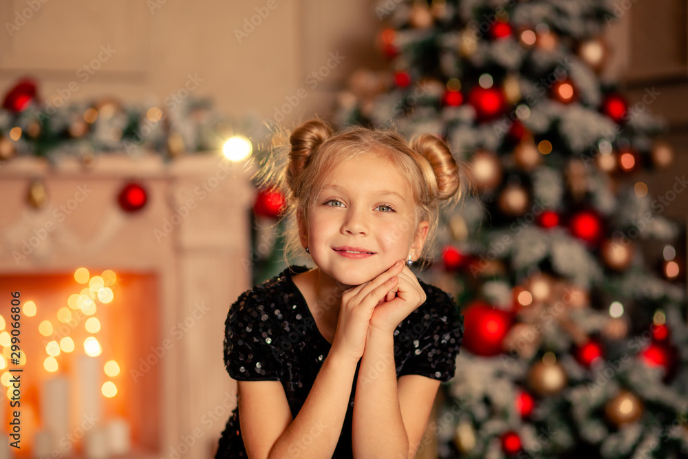portrait of a happy cute girl of 8-9 years old by the Christmas tree portrait of a happy cute girl of 8-9 years old by the Christmas tree