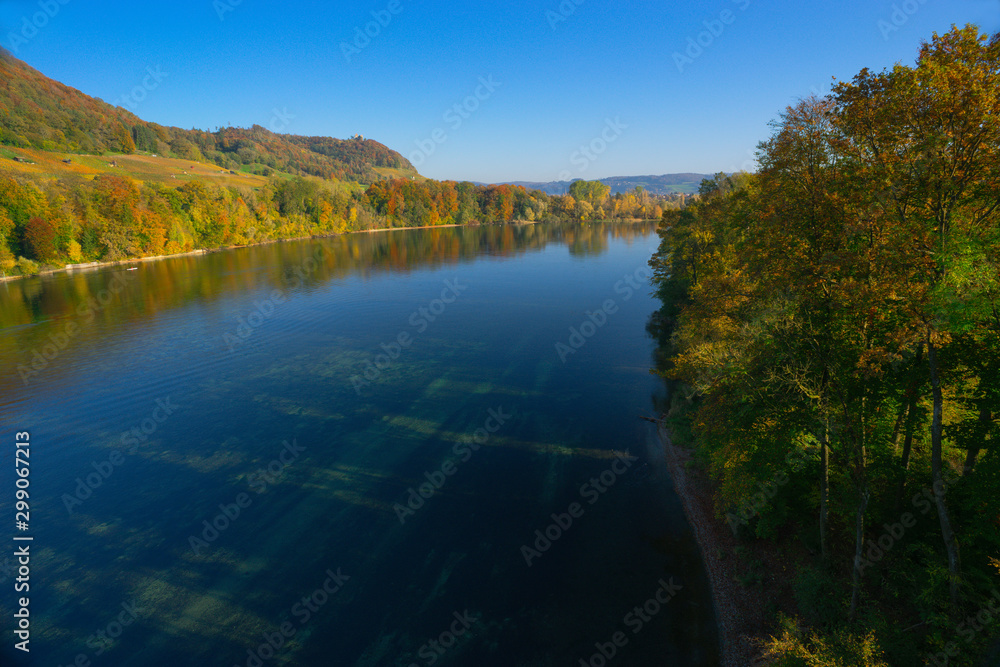The river Rhine, only a few hundred meters young, after leaving Lake Constance. Autumn. Near the Swiss town Stein am Rhein. View from the car bridge to the west, the road leads to the Rhine Falls.
