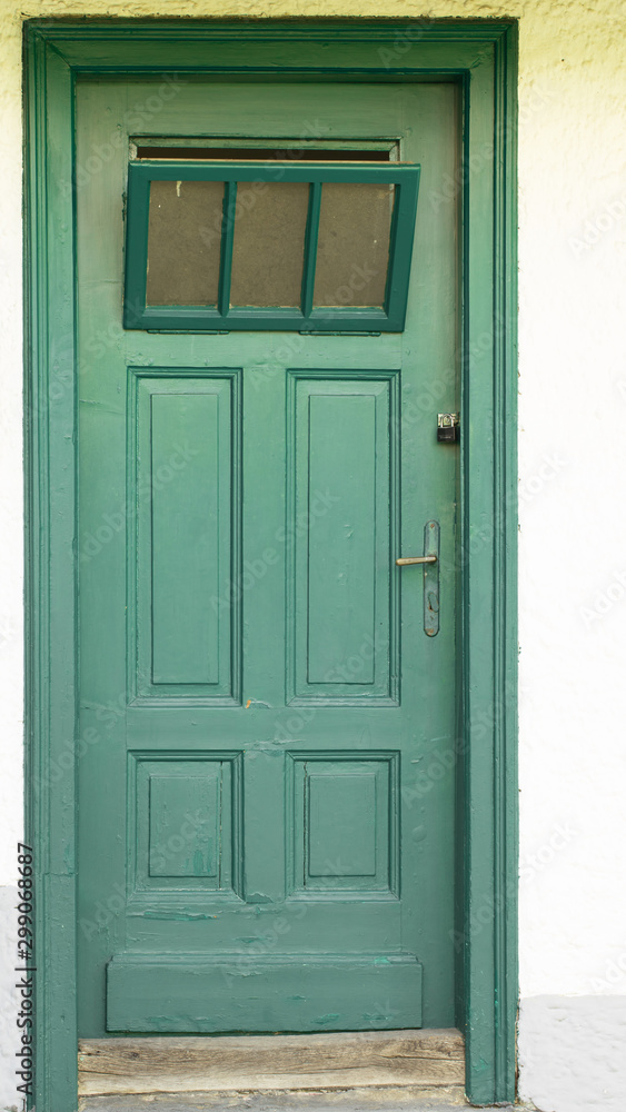 old wooden green door in austria