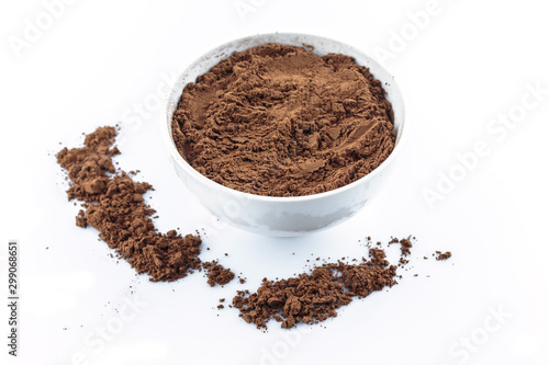 tasty cocoa powder in bowl top view on white background.