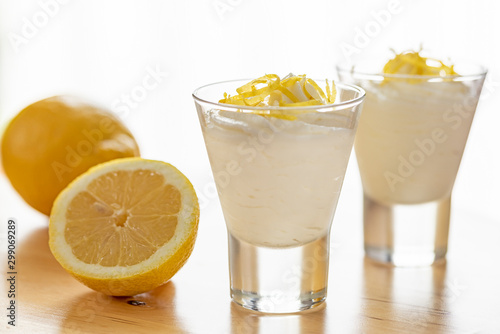 Lemon mousse into two conic glasses. Backlight. photo