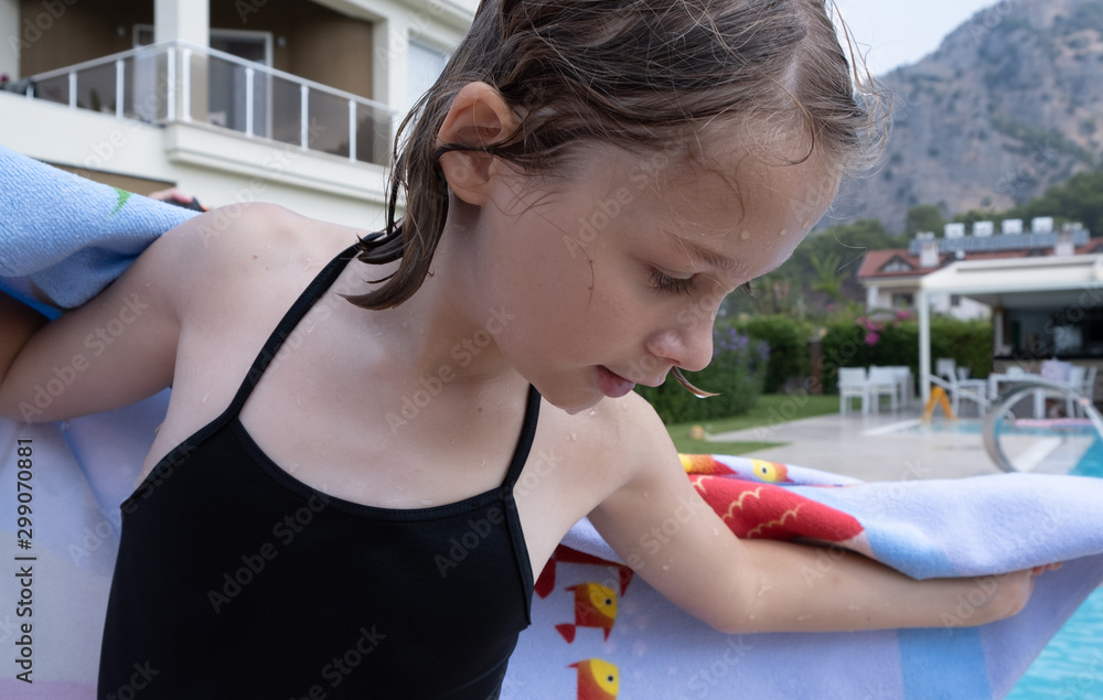 female child drying after a swim in the pool Stock Photo Adobe Stock