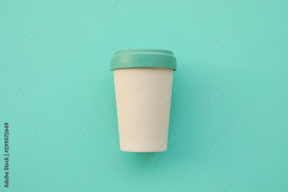 Reusable eco friendly bamboo cup for take away coffee on mint background. - obrazy, fototapety, plakaty 