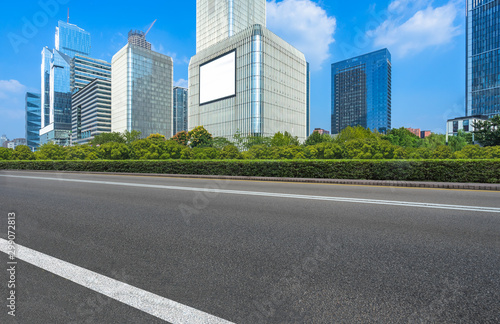 empty urban road with modern building in the city. © hallojulie