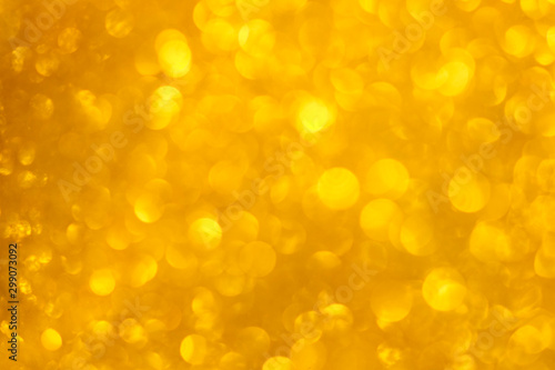 Yellow glitter bokeh lights background / Defocused illumination for holidays backgrounds