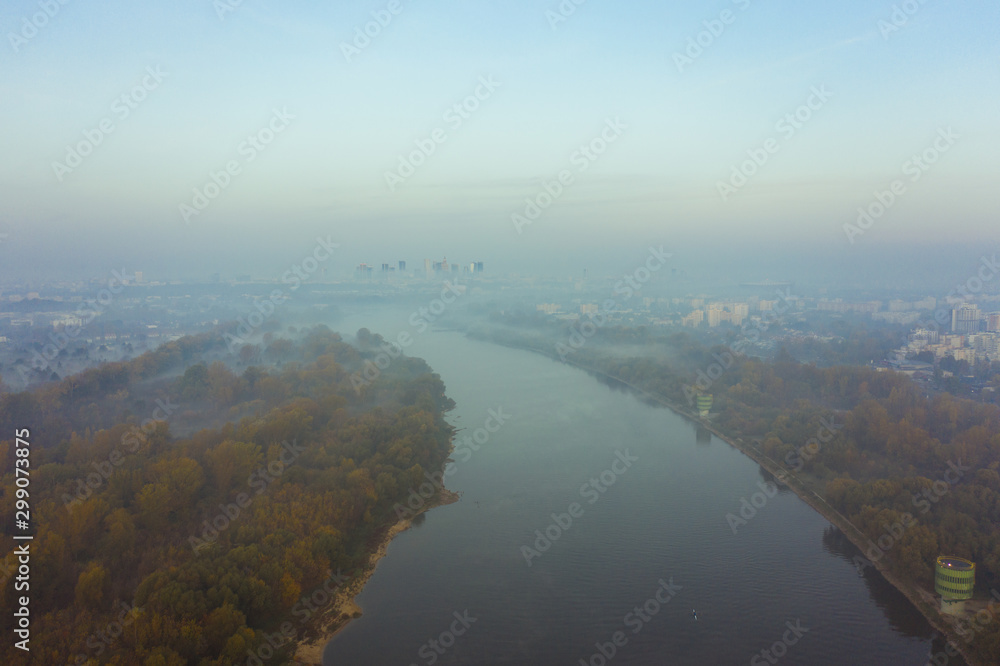 Drone shot on the Vistula river on a foggy morning in Warsaw. Poland. Aerial view of the Vistula River flowing through the city of Warsaw.