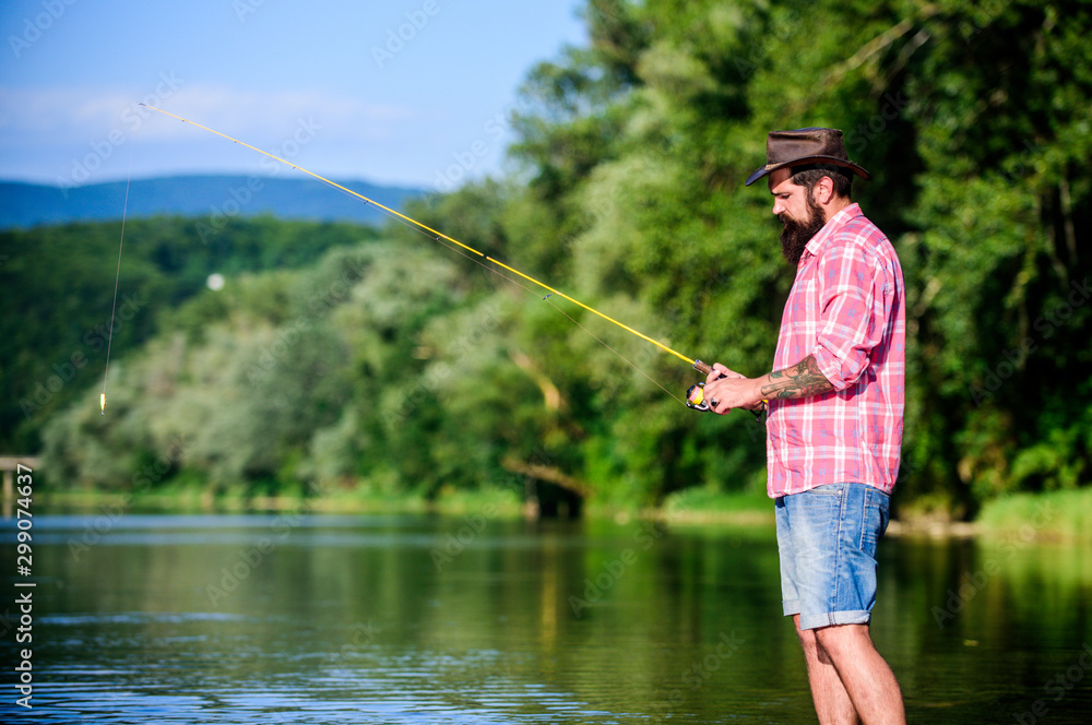 weekend relax. mature bearded man with fish on rod. hipster fishing with spoon-bait. fly fish hobby. Summer fishery activity. successful fisherman in lake water. big game fishing. relax on nature weekend relax. mature bearded man with fish on rod. hipster fishing with spoon-bait. fly fish hobby. Summer fishery activity. successful fisherman in lake water. big game fishing. relax on nature