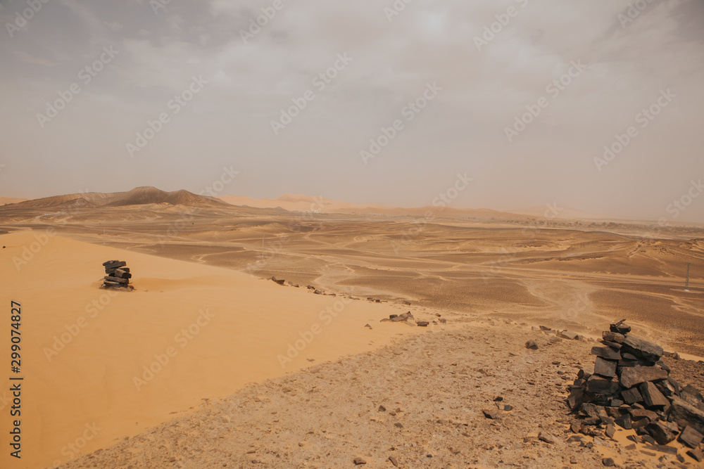 Moroccan desert landscape with dunes and arid terrain.