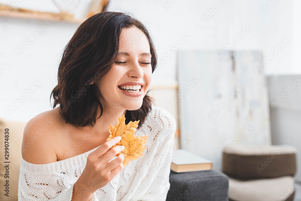 beautiful laughing girl holding yellow autumn at home beautiful laughing girl holding yellow autumn at home