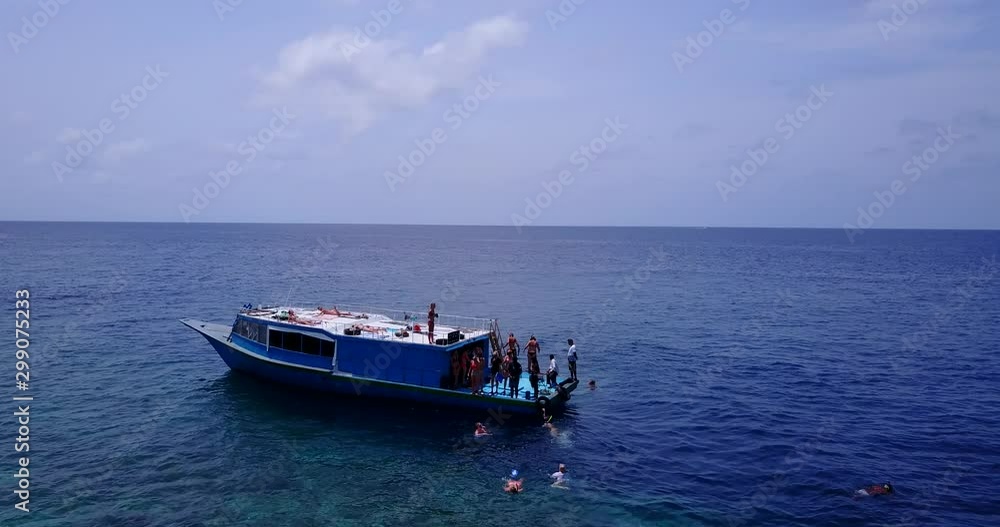 Tourists jumping from the boat into deep blue water of Indian ocean in a hot midday, near Seychelles Tourists jumping from the boat into deep blue water of Indian ocean in a hot midday, near Seychelles