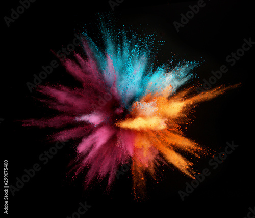 Foto Explosion of colored powder isolated on black background