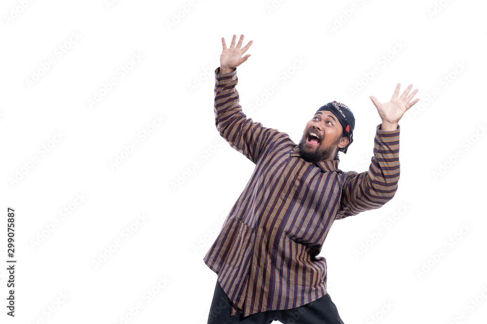 excited asian man with javanese traditional cloth lurik raised his arm happy