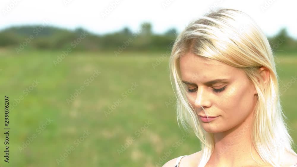 girl closing her eyes smelling flower, medium close up slow motion girl closing her eyes smelling flower, medium close up slow motion
