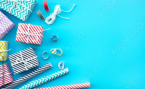 Celebration anniversary and party concepts ideas with colorful gift box present on blue color background