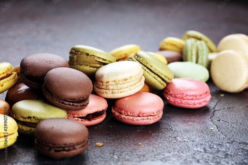 Sweet and colourful french macaroons or macaron on dark black background, Dessert. Sweet and colourful french macaroons or macaron on dark black background, Dessert.