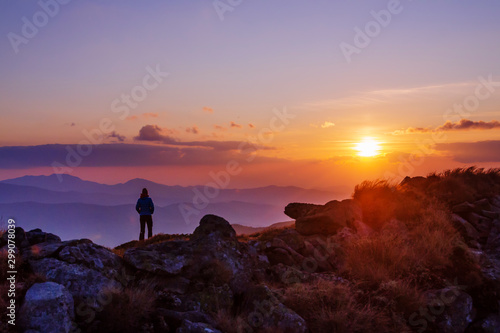 Tourist watching sunset in the mountains