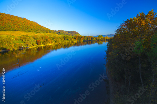 The river Rhine, only a few hundred meters young, after leaving Lake Constance. Autumn. Near the Swiss town Stein am Rhein. View from the car bridge to the west, the road leads to the Rhine Falls.