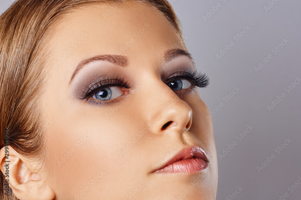 Woman face with eyes with long eyelashes and smokey eyes make-up. Eyelash makeup, cosmetics, beauty Woman face with eyes with long eyelashes and smokey eyes make-up. Eyelash makeup, cosmetics, beauty