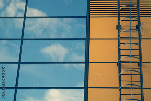 Glass wall of business center with sky reflection. modern building with large window