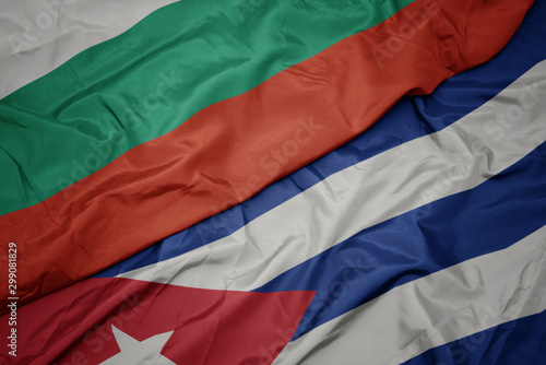 waving colorful flag of cuba and national flag of bulgaria.