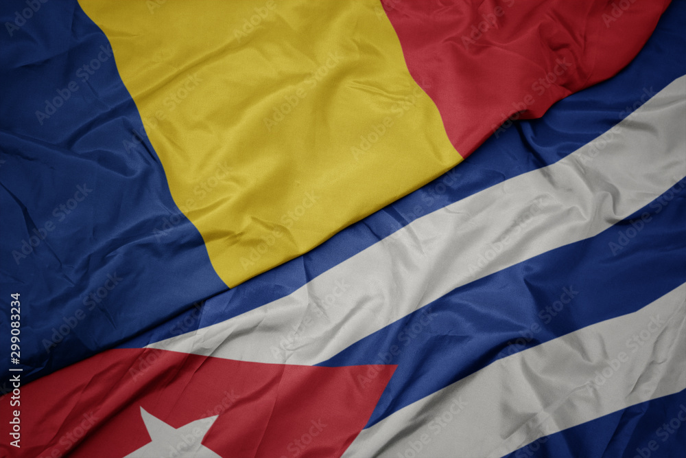 Fototapeta premium waving colorful flag of cuba and national flag of romania.