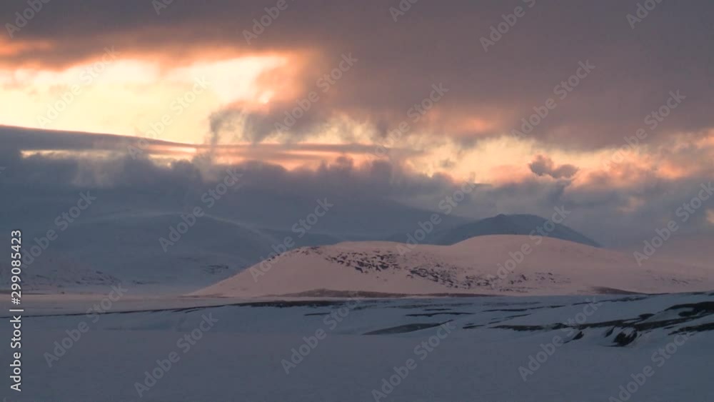 Sunset in the clouds over the snowy hills. Sunset in the clouds over the snowy hills.