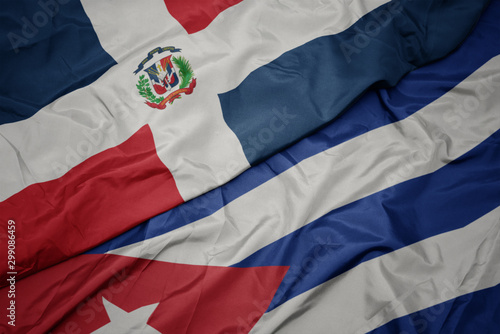 Photography waving colorful flag of cuba and national flag of dominican republic
