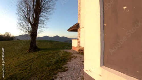 4K Forward moving on hilltop with church wall on right side on Bukov Vrh, Slovenia photo