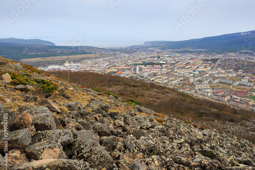 View from the mountains on the city of Magadan. Magadan is located among the mountains on the coast of the Sea of ​​Okhotsk. The administrative center of the Magadan region, Russia. Russian Far East.