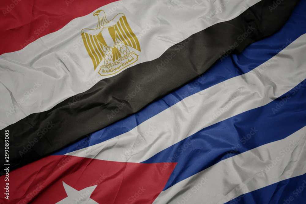 waving colorful flag of cuba and national flag of egypt .